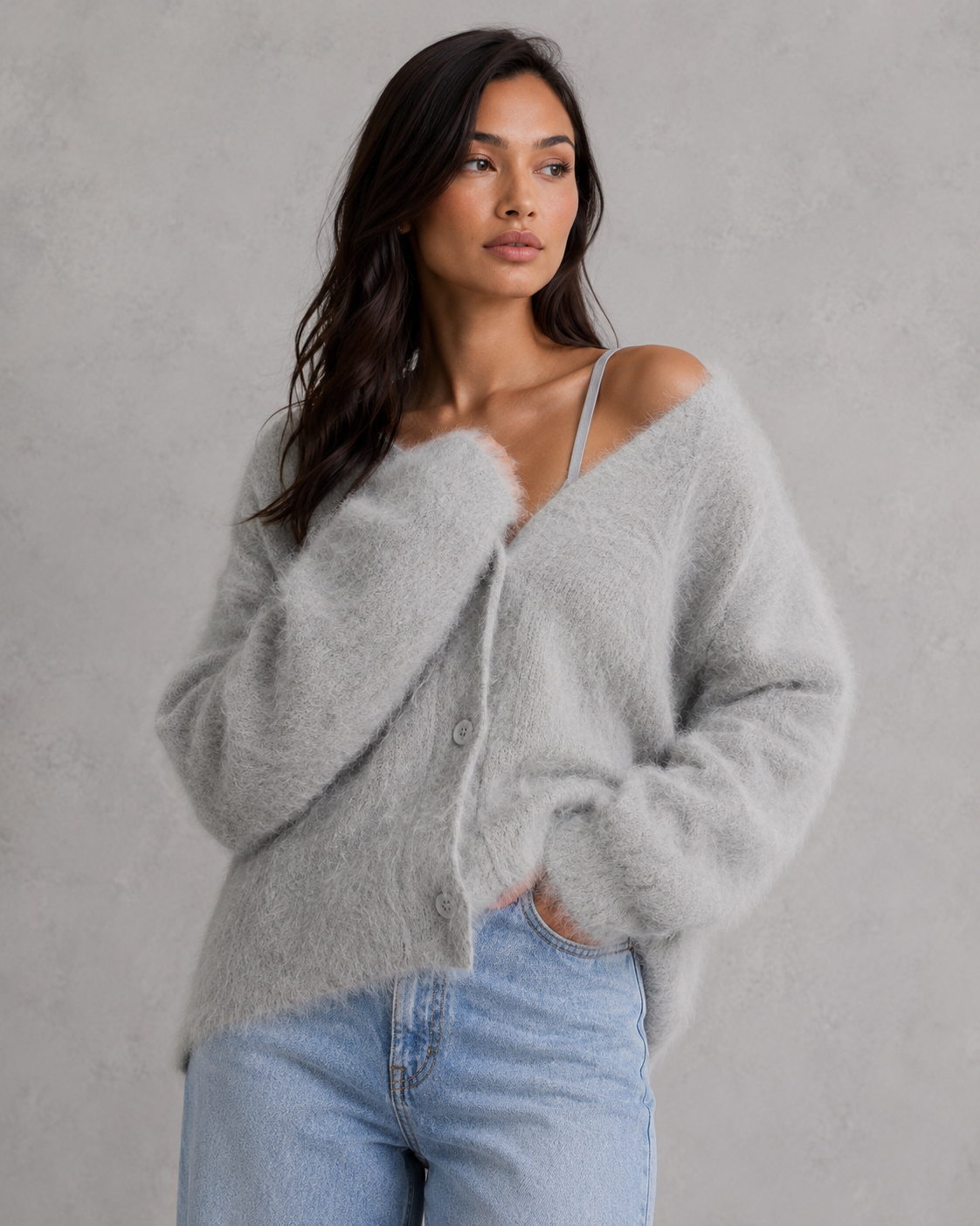 Woman wearing a soft button-front knit cardigan in a relaxed fit, styled for elegant autumn and winter layering.