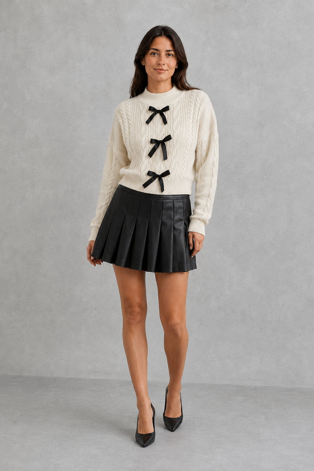 Women’s cable knit cardigan with long sleeves, classic textured detailing and feminine bow tie accents for cozy everyday layering.