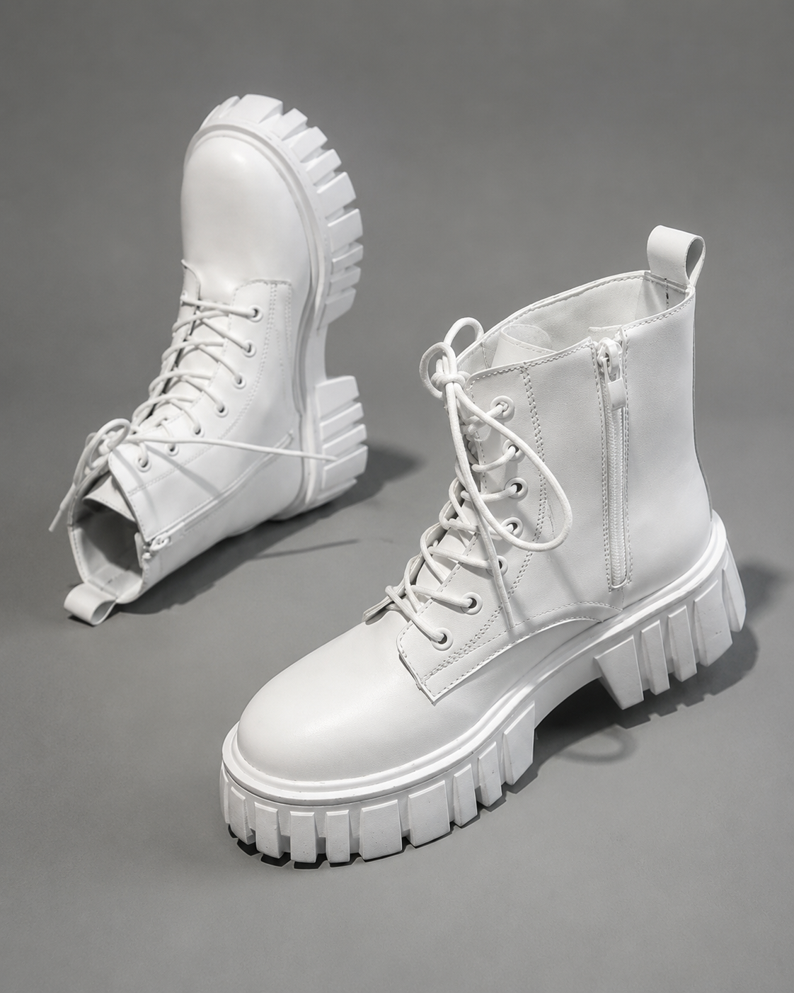 Women's chunky sole combat boots with a lace-up design, ankle-height silhouette, square heel and durable rubber sole for everyday casual wear.