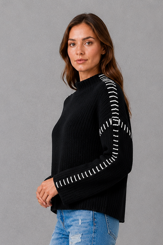 Women’s black oversized crew neck sweater with long sleeves and statement white contrast stitching along the shoulders and sleeves.