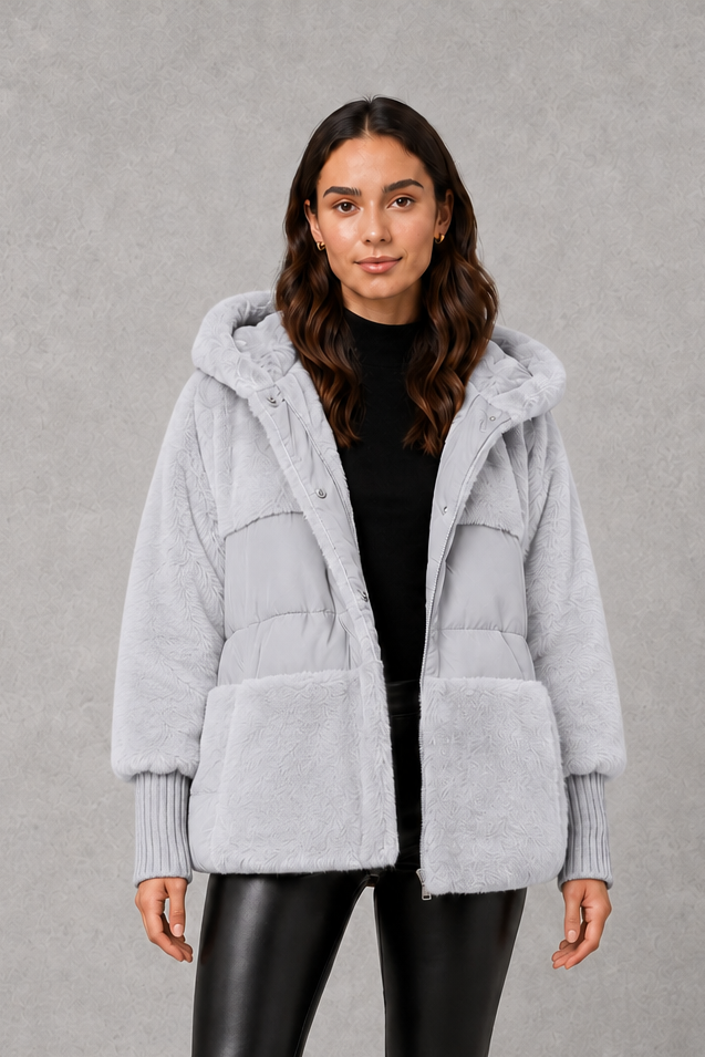 Women’s cozy hooded longline coat with a soft inner lining, attached hood, smooth outer fabric, and comfortable regular fit for winter layering.