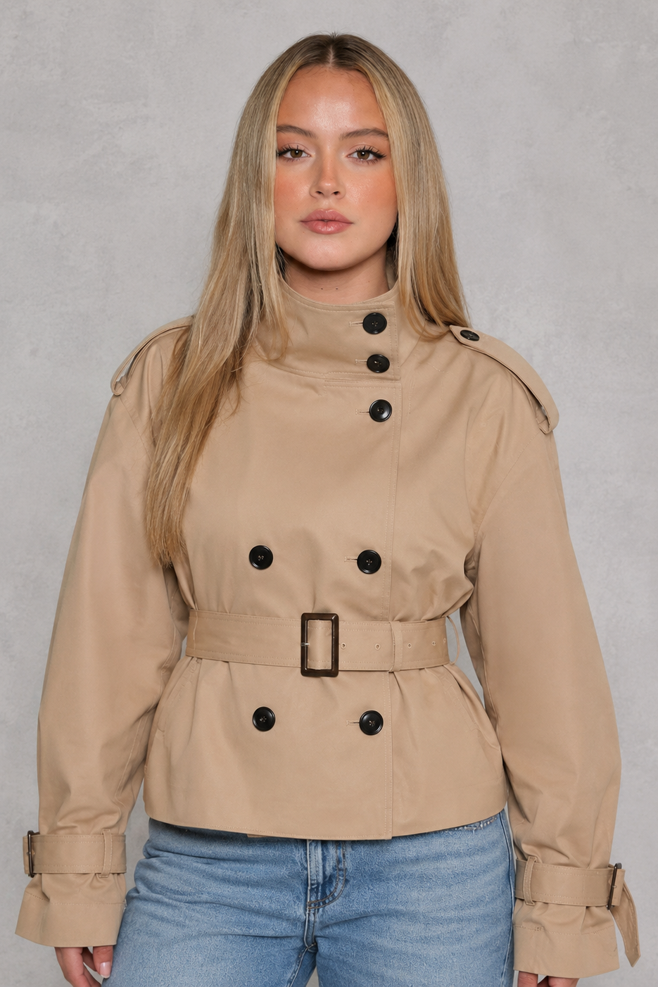 Women’s cropped belted trench coat with a double-breasted button front, structured lapel collar and adjustable tie waist.
