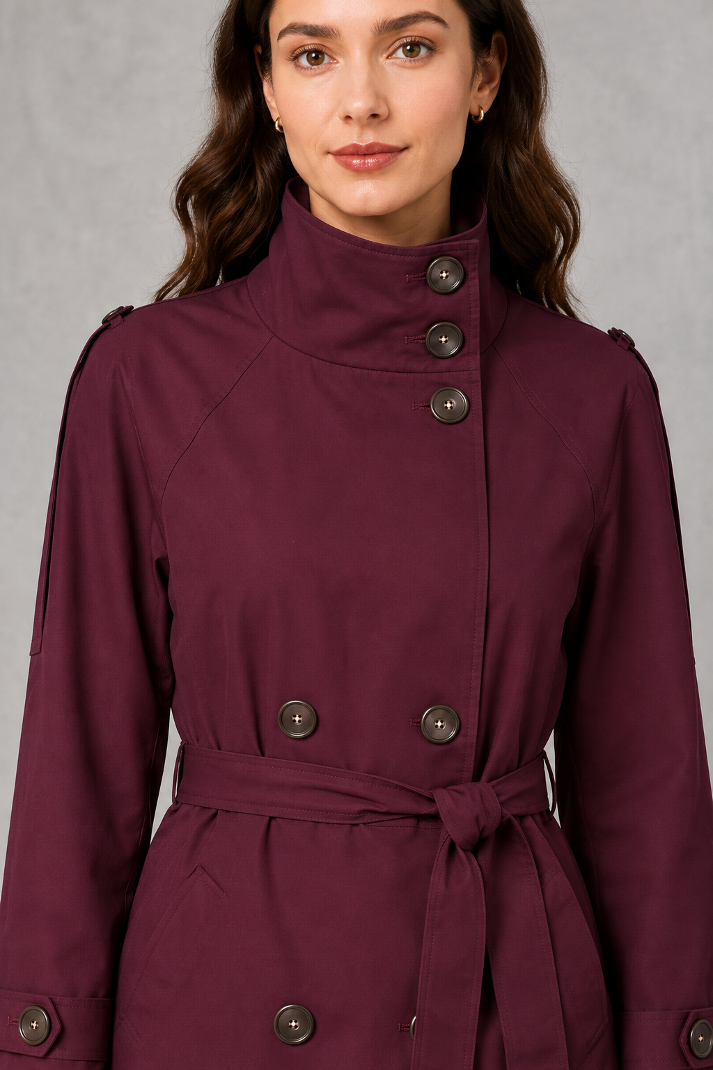 Women’s cropped double-breasted jacket with a high collar, statement buttons, adjustable waist belt, and softly structured lightweight silhouette.