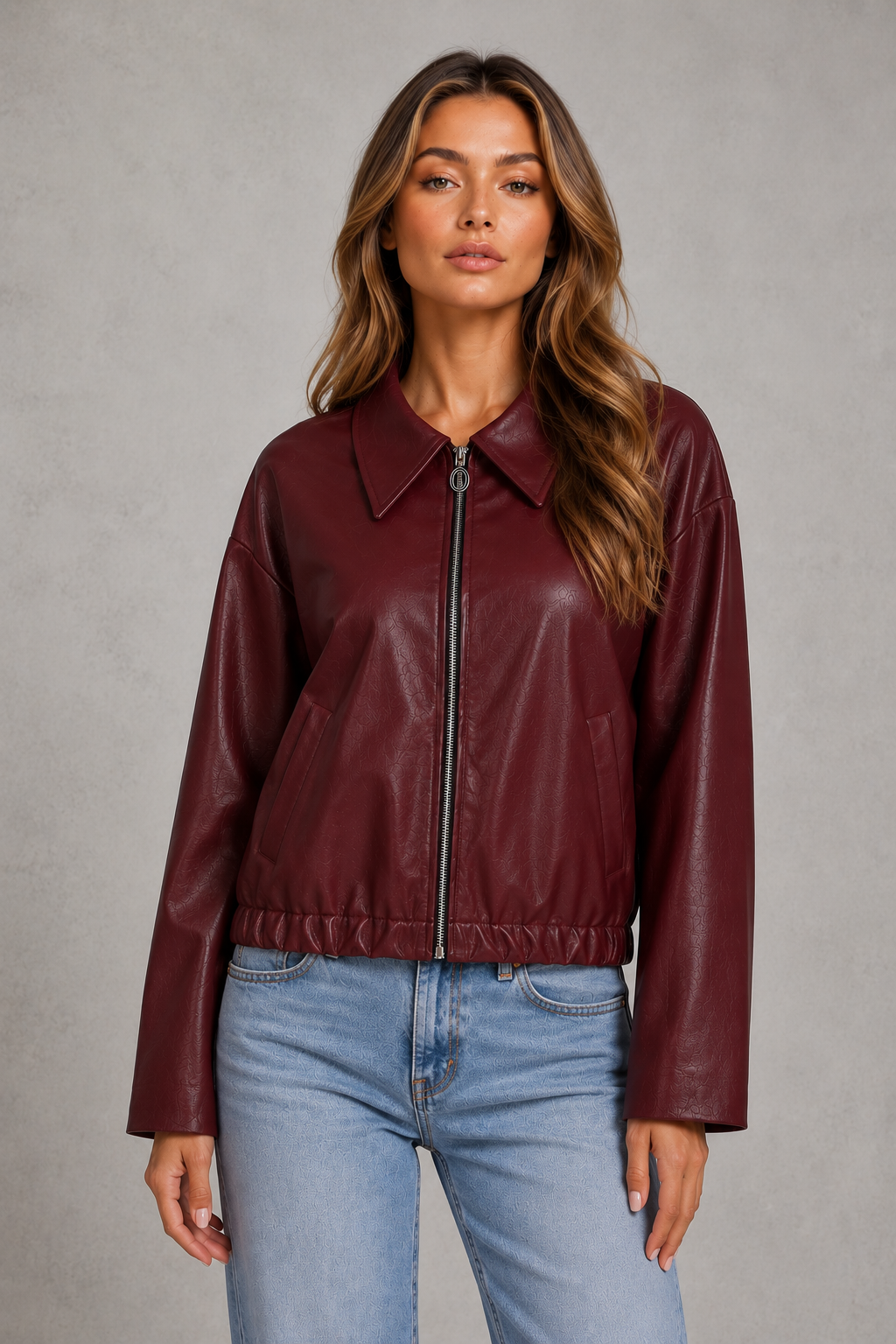 Women’s cropped faux leather jacket with zip front, oversized pointed collar, elasticized hem, and side pockets in a relaxed fit.