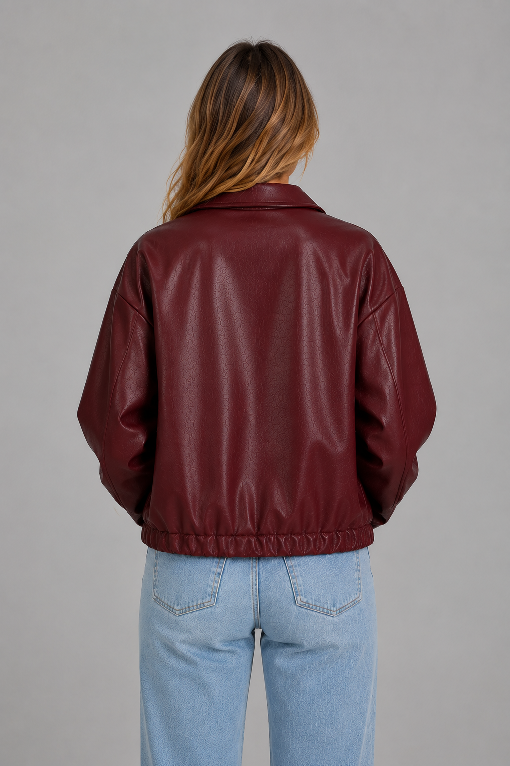 Women’s cropped faux leather jacket with zip front, oversized pointed collar, elasticized hem, and side pockets in a relaxed fit.