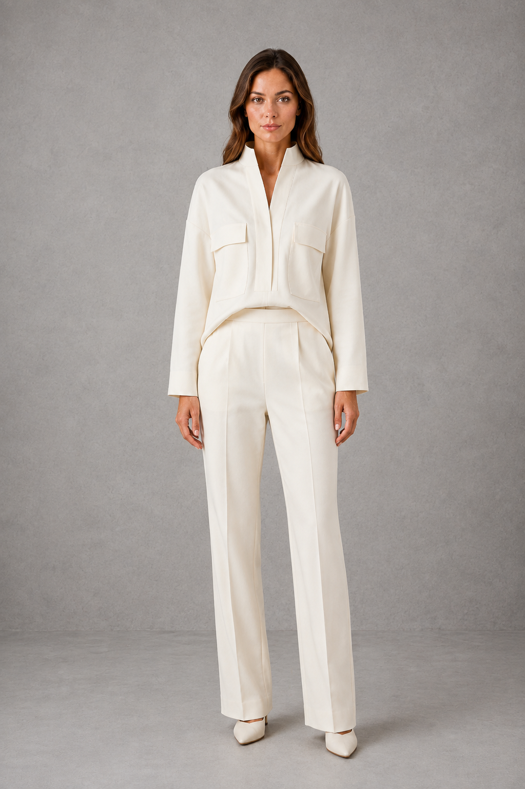 Women’s two-piece set featuring a cropped oversized V-neck jacket with patch pockets and matching high-waisted cigarette pants.