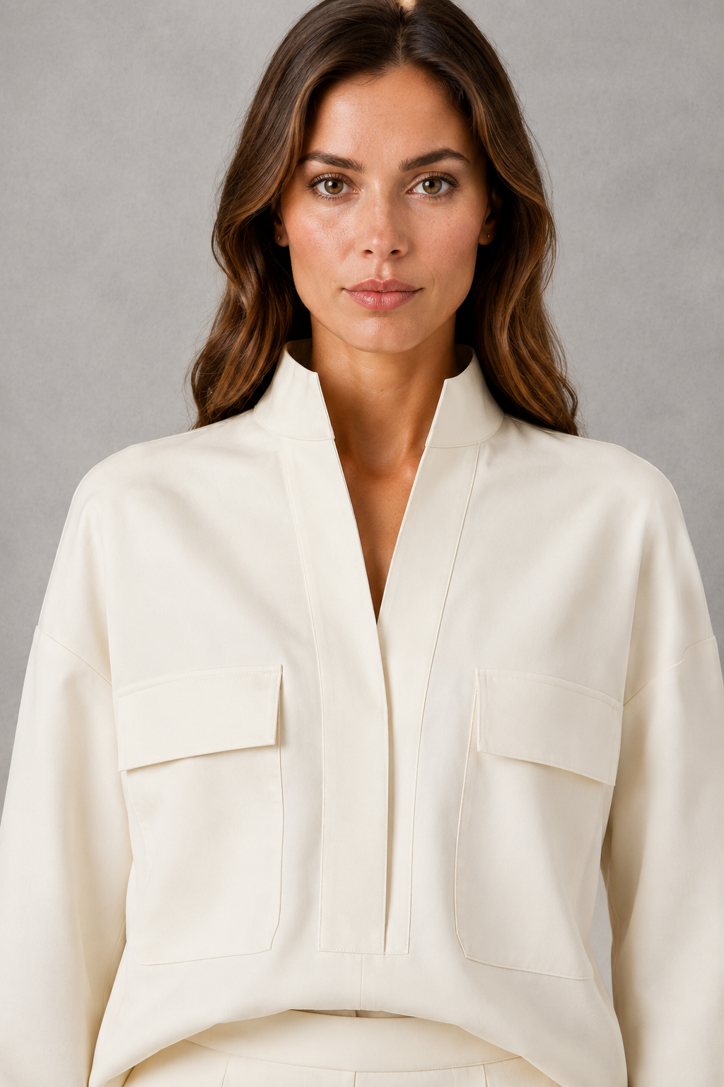Women’s two-piece set featuring a cropped oversized V-neck jacket with patch pockets and matching high-waisted cigarette pants.