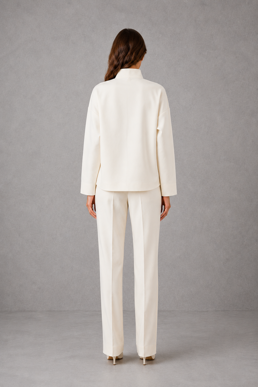 Women’s two-piece set featuring a cropped oversized V-neck jacket with patch pockets and matching high-waisted cigarette pants.