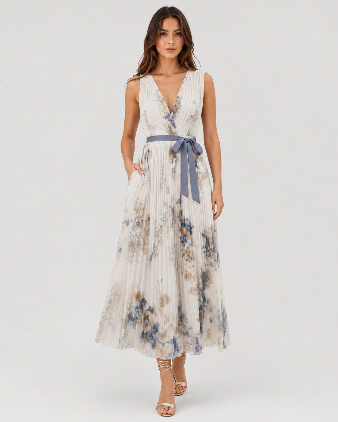 Women’s floral pleated maxi dress with a V-neckline and flowing chiffon silhouette, featuring an all-over floral print and lightweight pleated skirt for elegant movement.
