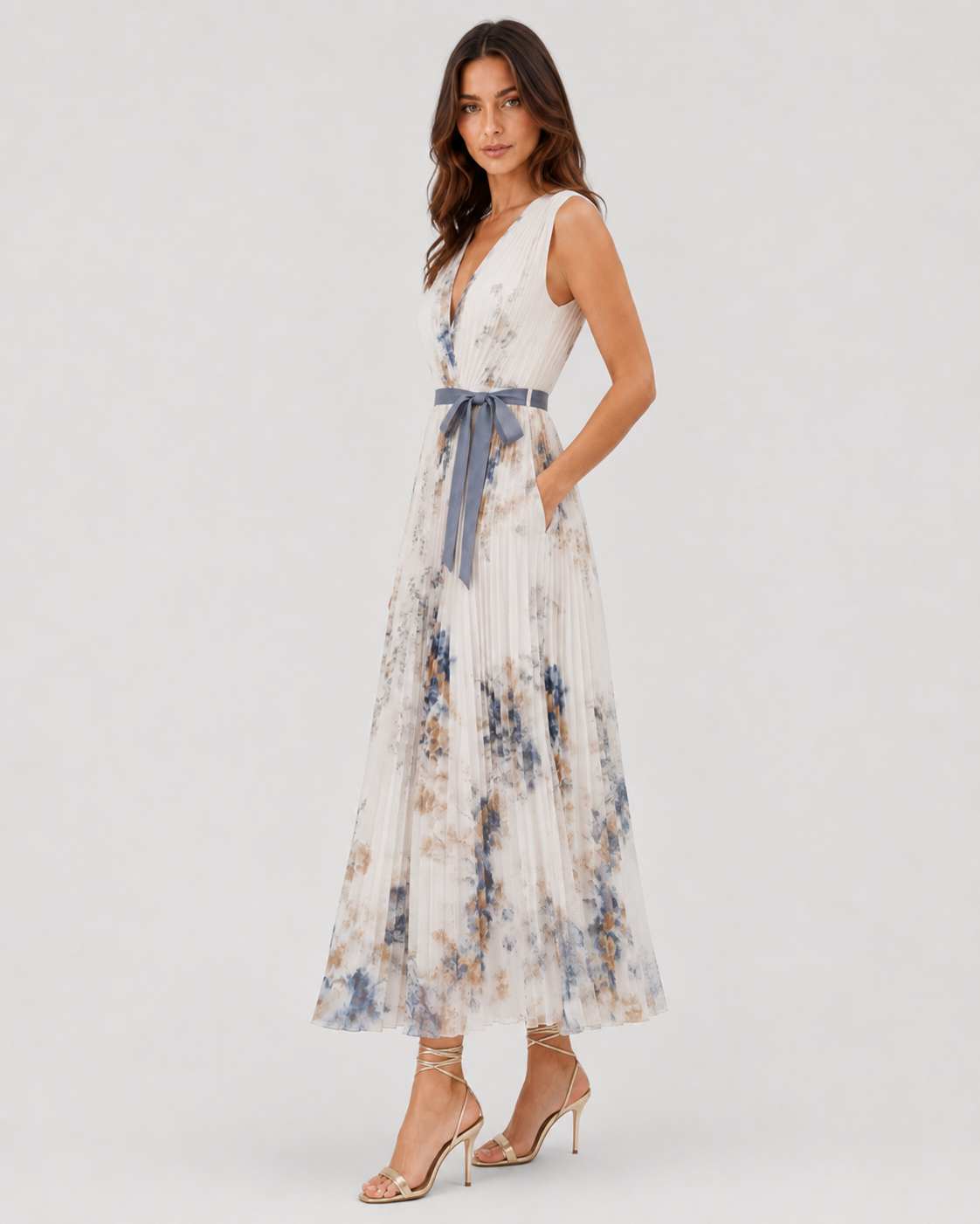 Women’s floral pleated maxi dress with a V-neckline and flowing chiffon silhouette, featuring an all-over floral print and lightweight pleated skirt for elegant movement.