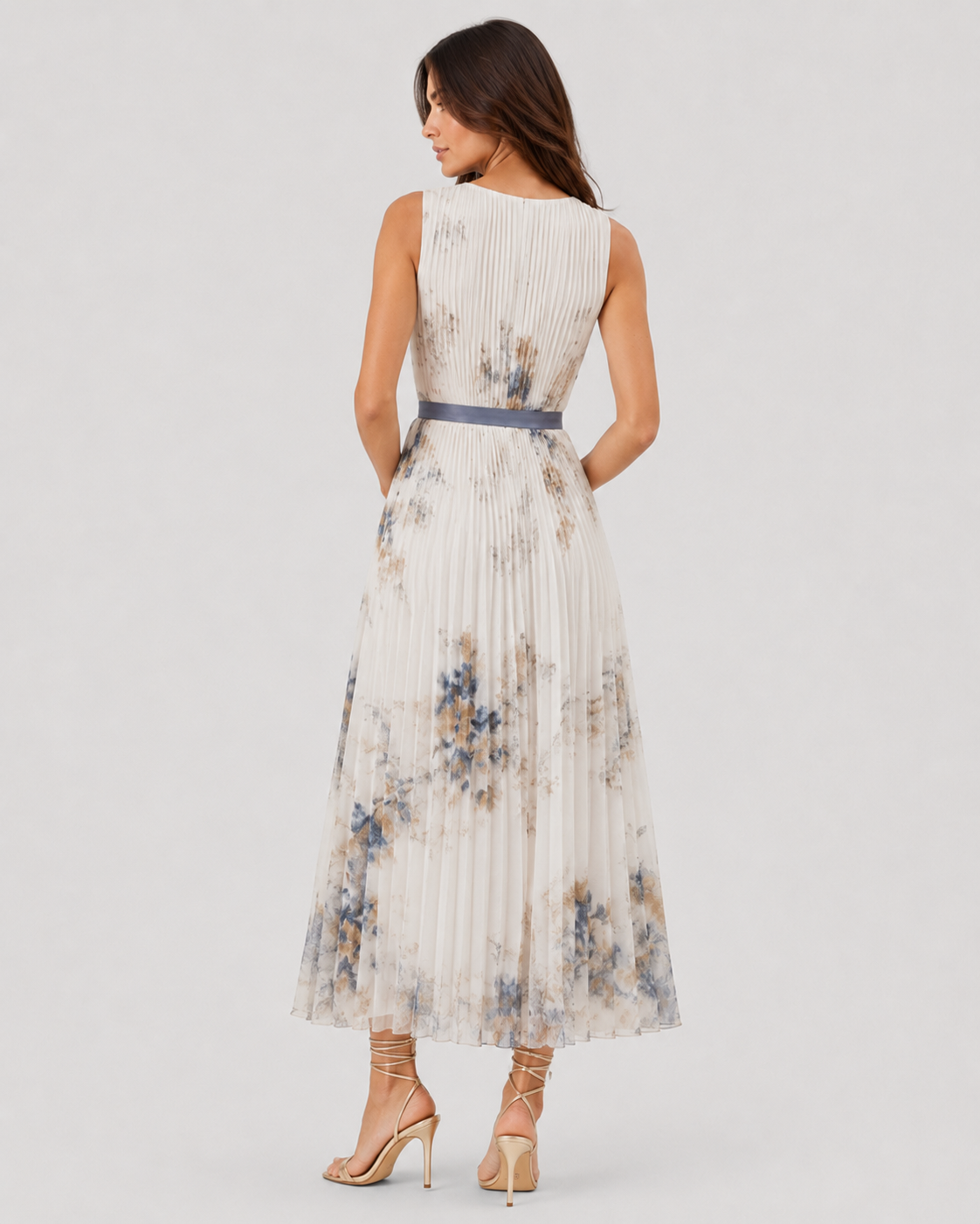 Women’s floral pleated maxi dress with a V-neckline and flowing chiffon silhouette, featuring an all-over floral print and lightweight pleated skirt for elegant movement.