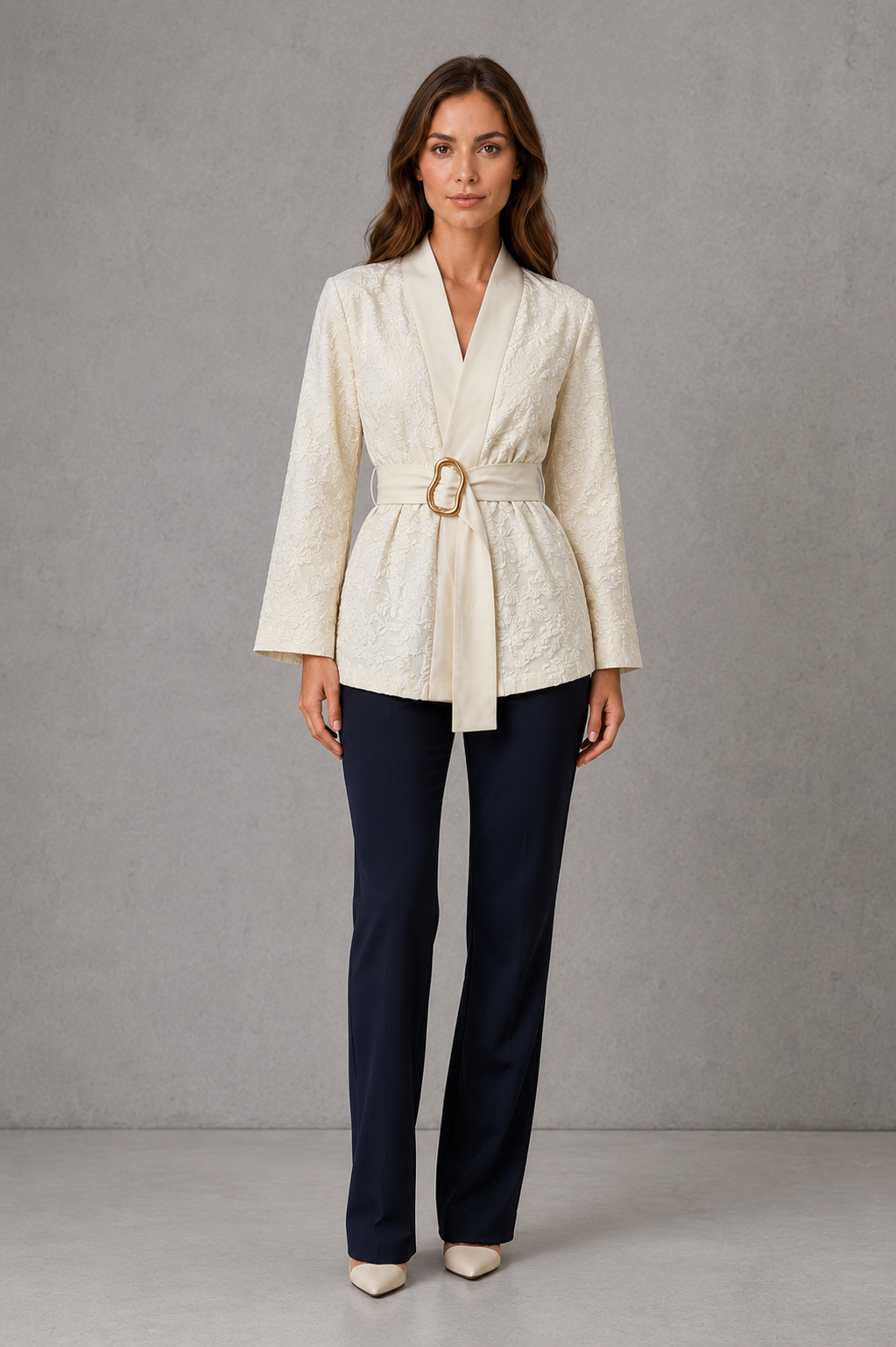 Women’s soft apricot floral wrap blouse with a V-neckline, flowing bell sleeves, pleated waist and matching belt with a gold-tone buckle.