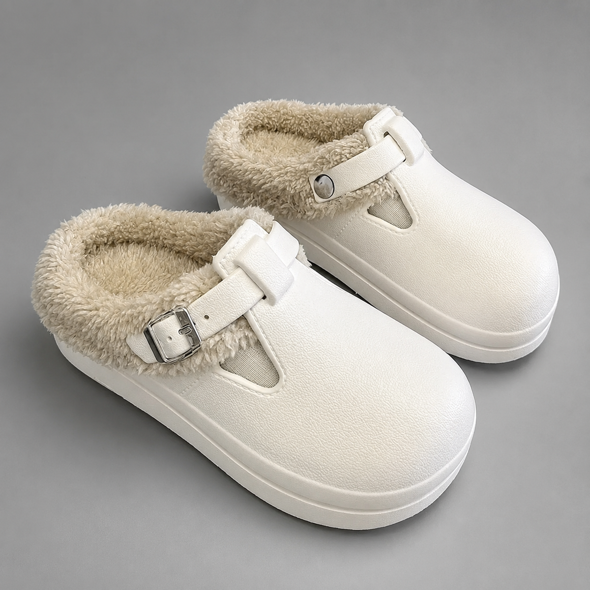 Women’s fur-lined mule slippers with a waterproof upper, plush faux fur lining, metal buckle accent, cushioned sole, and open-back slip-on design.