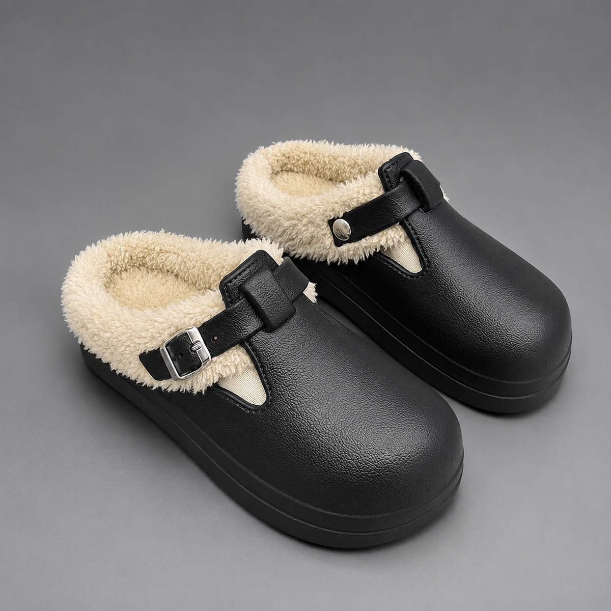 Women’s fur-lined mule slippers with a waterproof upper, plush faux fur lining, metal buckle accent, cushioned sole, and open-back slip-on design.