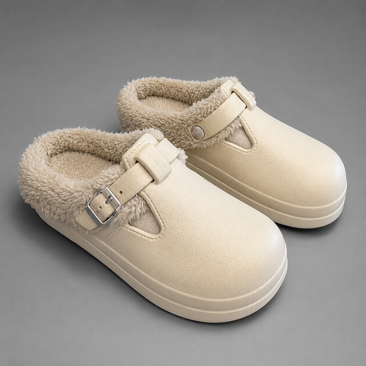 Women’s fur-lined mule slippers with a waterproof upper, plush faux fur lining, metal buckle accent, cushioned sole, and open-back slip-on design.