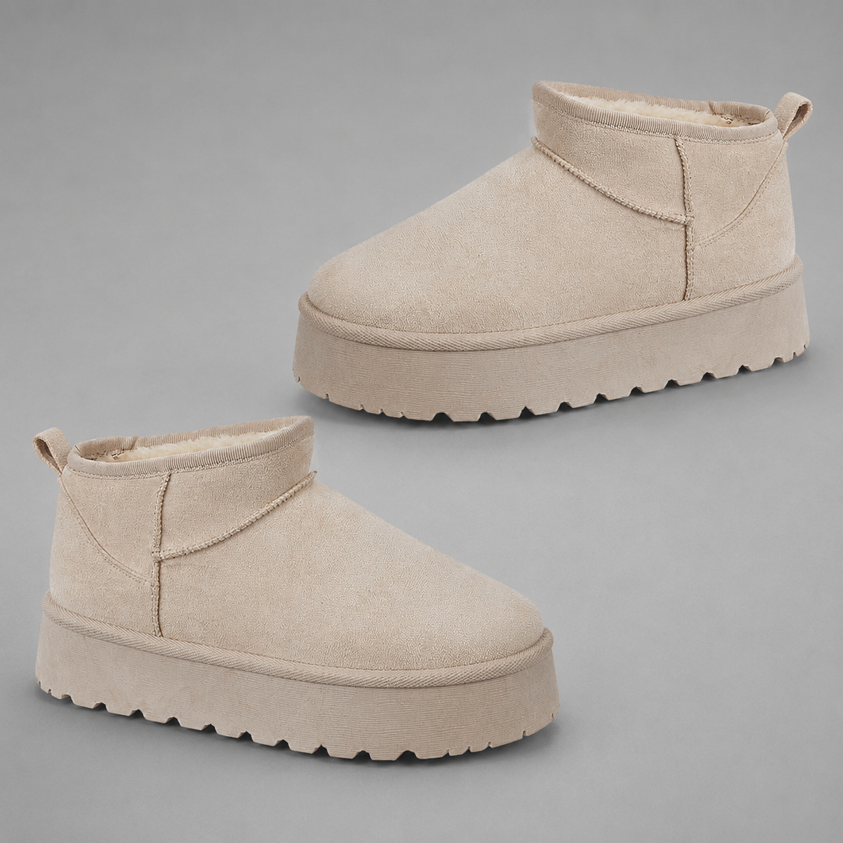 Women’s fur-lined platform snow boots with a soft faux suede upper, plush lining, round toe, back pull tab, and chunky platform sole.