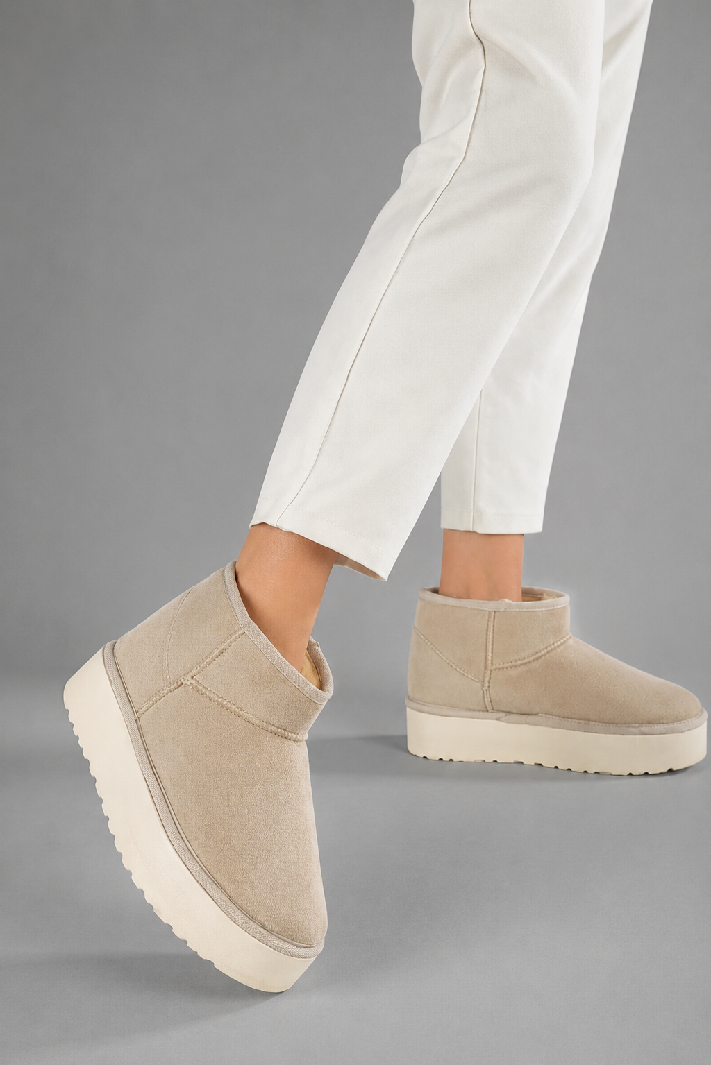 Women’s fur-lined platform snow boots with a soft faux suede upper, plush lining, round toe, back pull tab, and chunky platform sole.
