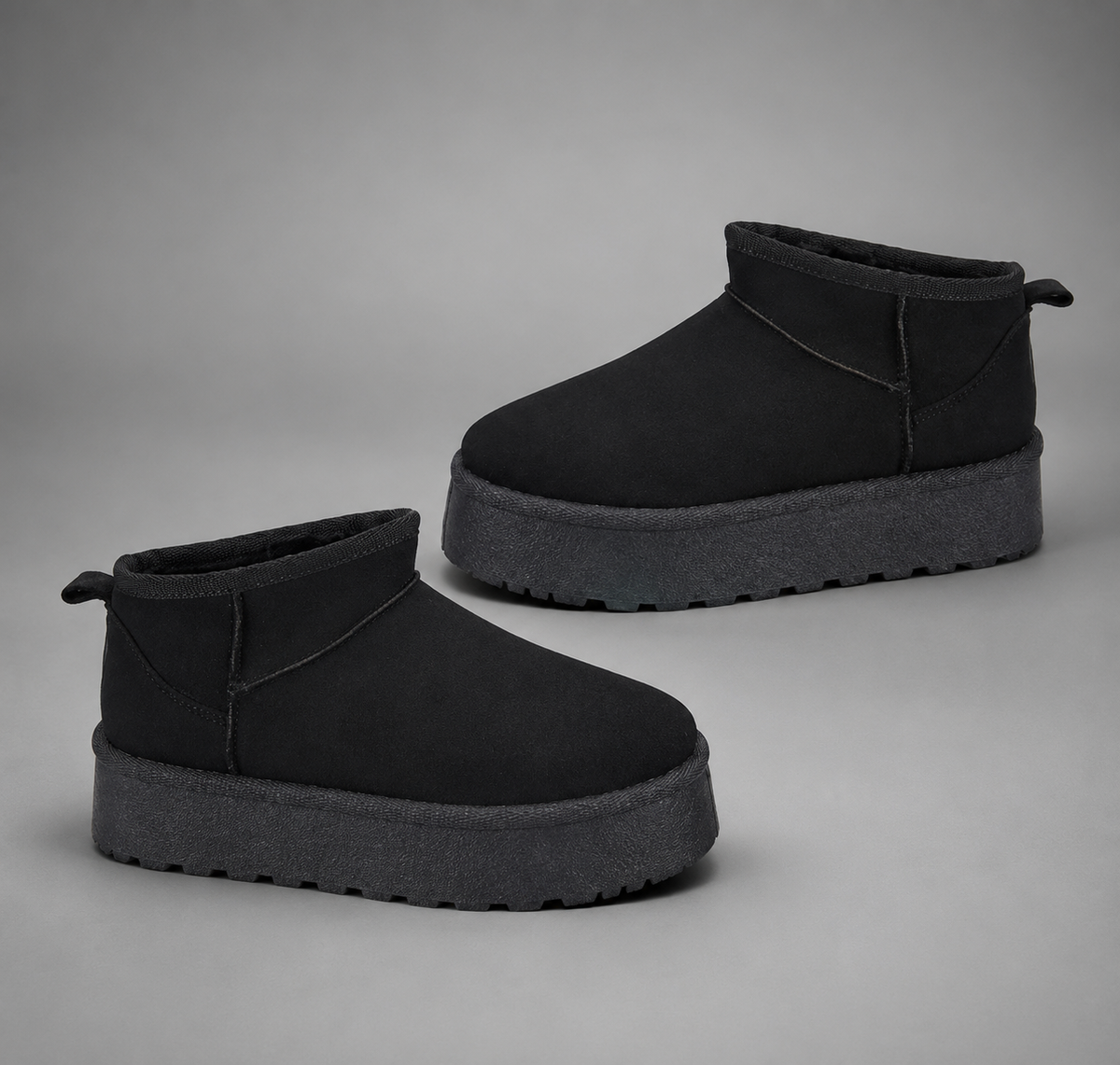 Women’s fur-lined platform snow boots with a soft faux suede upper, plush lining, round toe, back pull tab, and chunky platform sole.