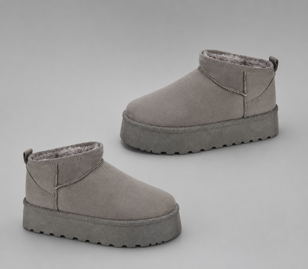Women’s fur-lined platform snow boots with a soft faux suede upper, plush lining, round toe, back pull tab, and chunky platform sole.