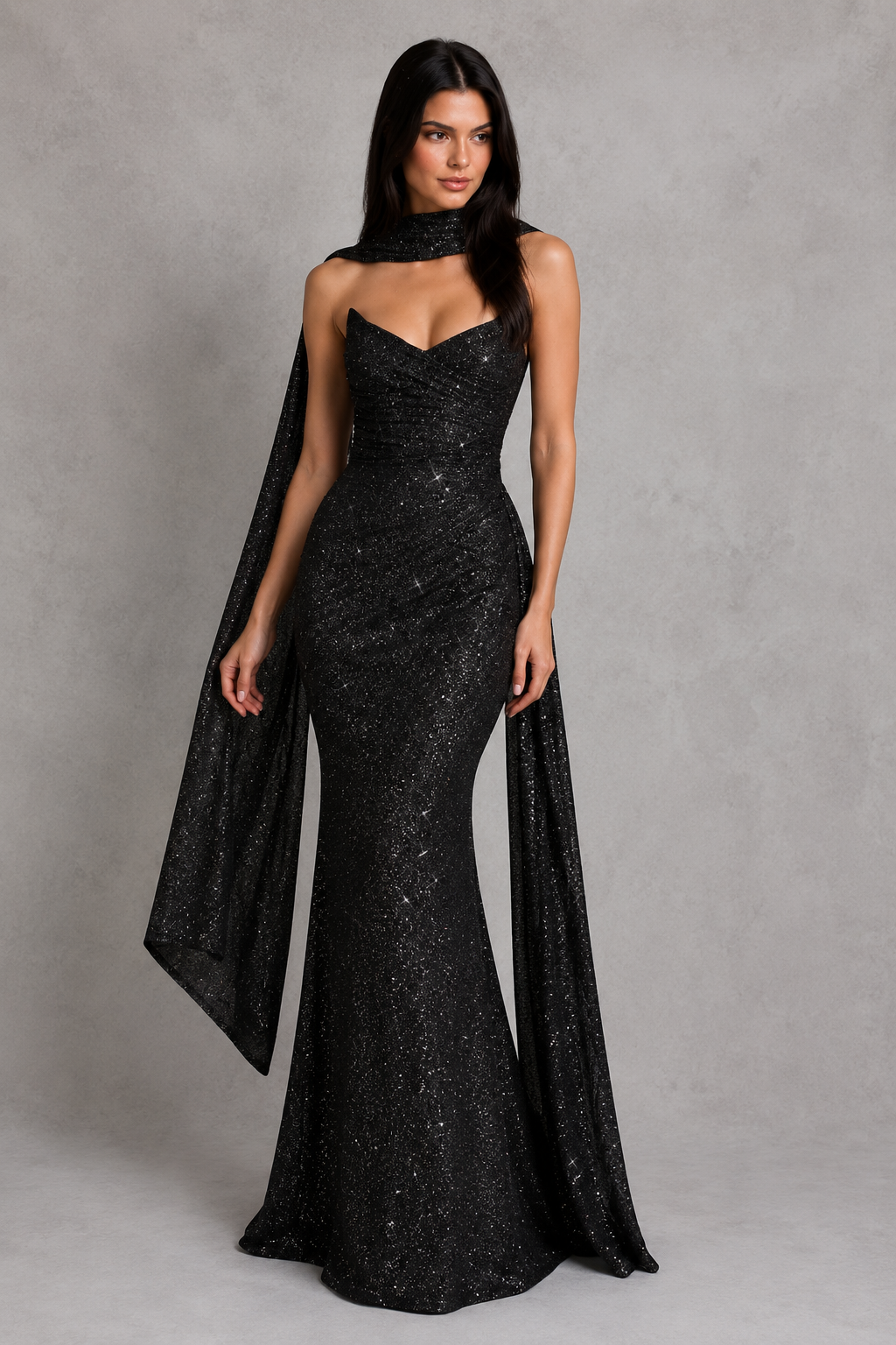 Women's glitter maxi dress with a strapless plunge neckline, wrap-effect ruched bodice, internal boning, draped hip panel, and flowing fit-and-flare godet skirt for elegant evening and formal occasions.