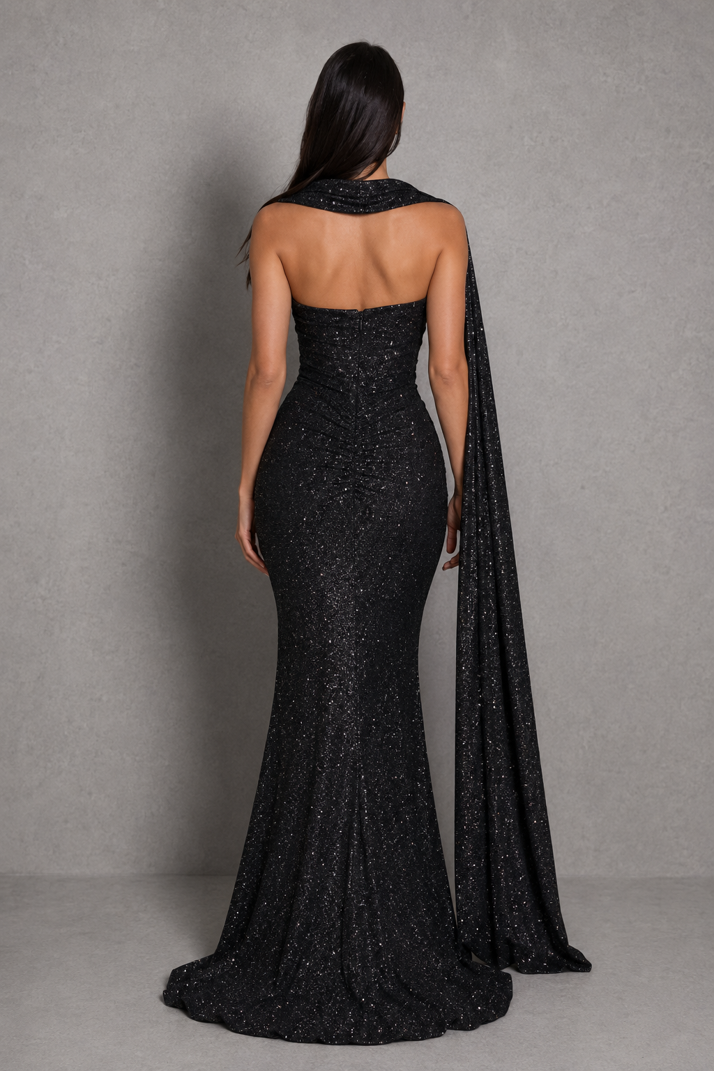 Women's glitter maxi dress with a strapless plunge neckline, wrap-effect ruched bodice, internal boning, draped hip panel, and flowing fit-and-flare godet skirt for elegant evening and formal occasions.