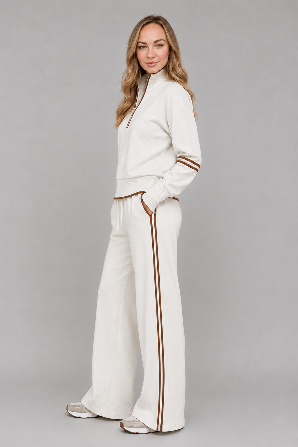 Women’s half-zip lounge set with a relaxed funnel-neck sweatshirt, contrast stripe detailing, and matching wide-leg drawstring pants.