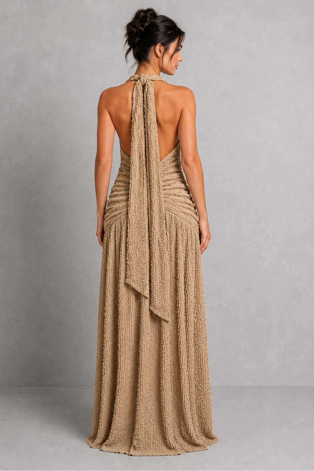 Woman wearing a women’s halter maxi dress with a deep plunge neckline, ruched hips, low V-shaped back, flowing gathered skirt, thigh-high split, and textured stretch fabric for an elegant evening look.