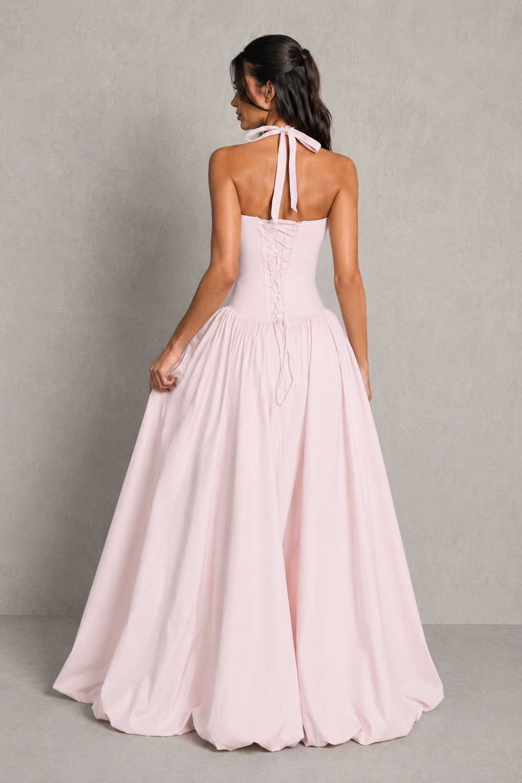 Women's halter maxi dress with a structured boned bodice, gathered bust, dropped waist, voluminous puffball skirt, thigh-high split, and lace-up back in premium poplin fabric for evening and formal occasions.