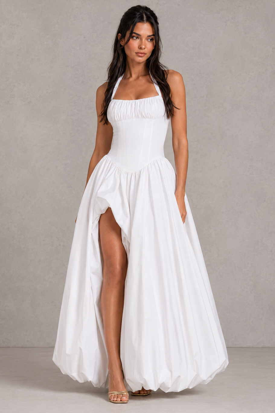 Women's halter maxi dress with a structured boned bodice, gathered bust, dropped waist, voluminous puffball skirt, thigh-high split, and lace-up back in premium poplin fabric for evening and formal occasions.