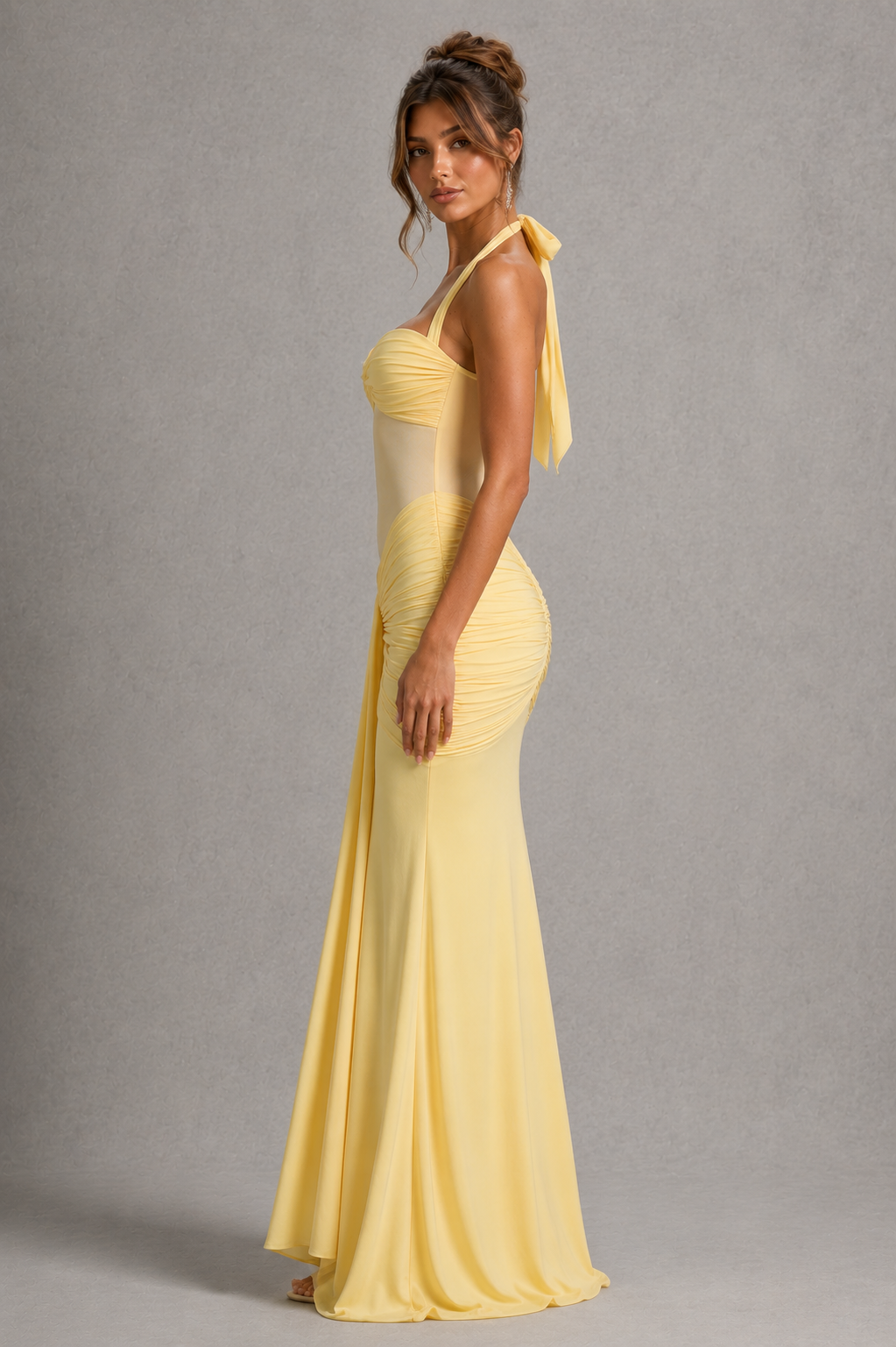 Woman wearing a women’s halter maxi dress with a sheer mesh bodice, sweetheart twist neckline, ruched hips, adjustable halter ties, and a flowing fit-and-flare skirt for evening and formal occasions.