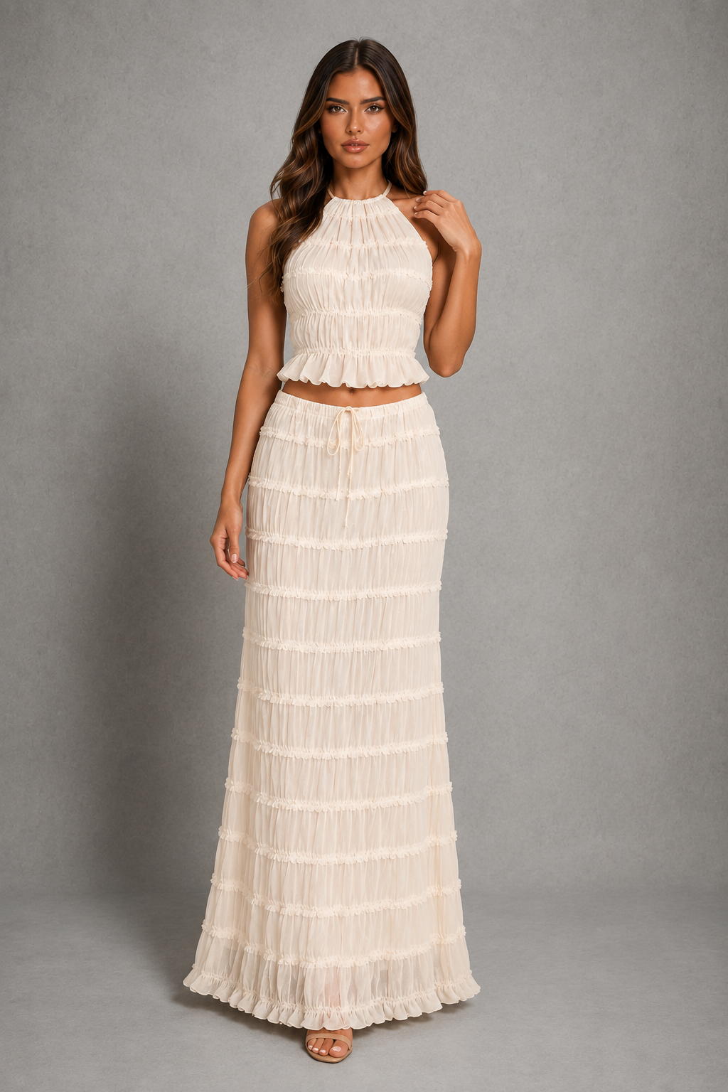 Women’s halterneck two-piece set with a gathered shirred top and matching flowing maxi skirt with an adjustable tie waist.