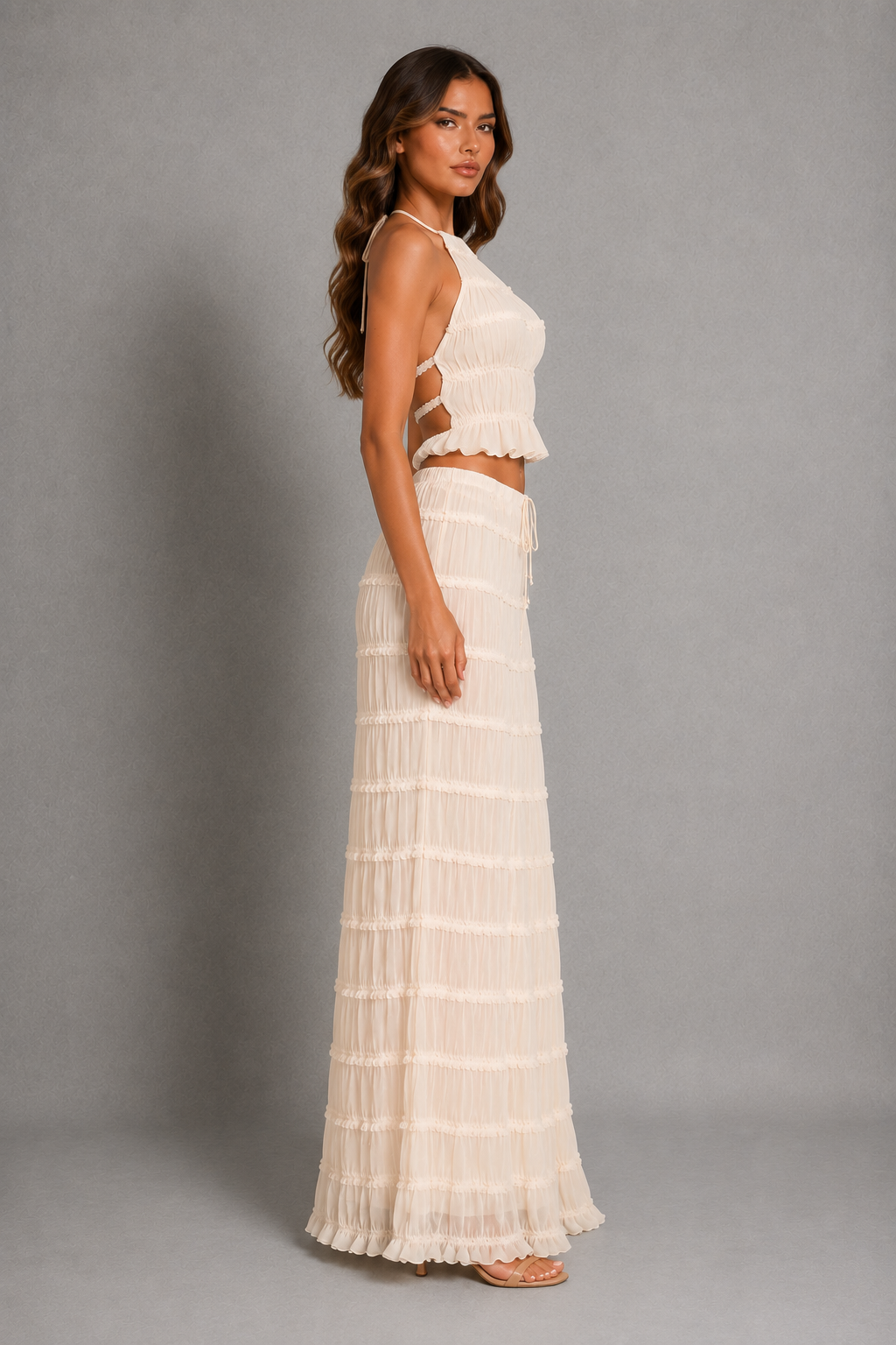 Women’s halterneck two-piece set with a gathered shirred top and matching flowing maxi skirt with an adjustable tie waist.