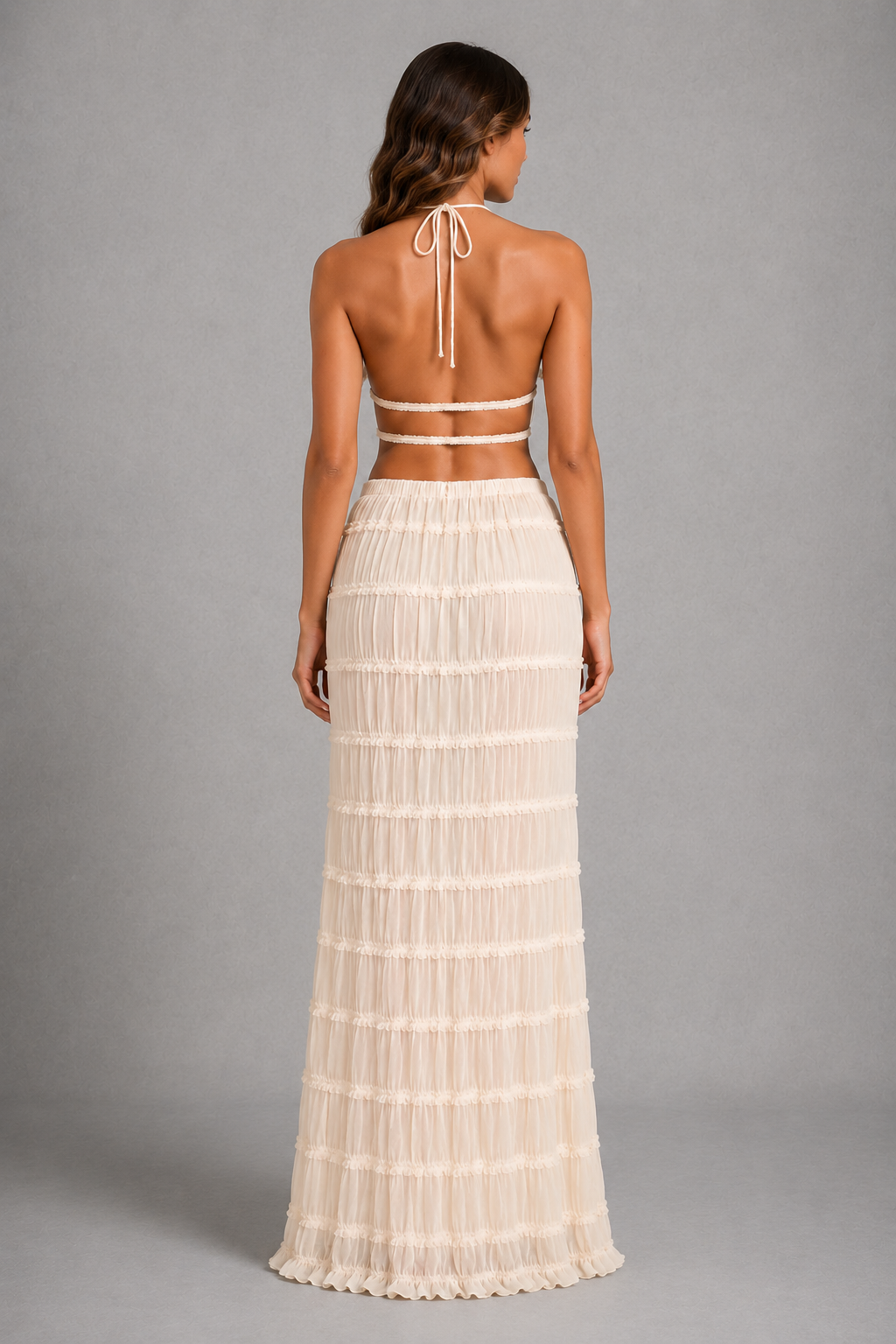 Women’s halterneck two-piece set with a gathered shirred top and matching flowing maxi skirt with an adjustable tie waist.