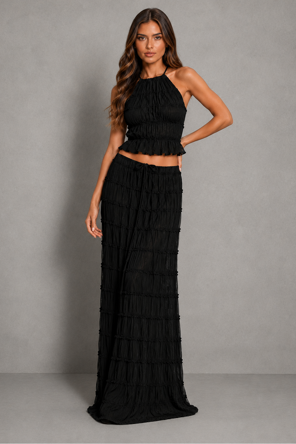 Women’s halterneck two-piece set with a gathered shirred top and matching flowing maxi skirt with an adjustable tie waist.