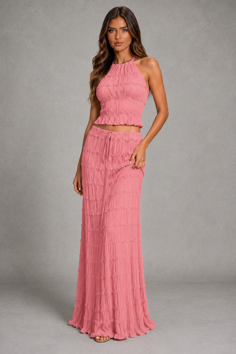 Women’s halterneck two-piece set with a gathered shirred top and matching flowing maxi skirt with an adjustable tie waist.