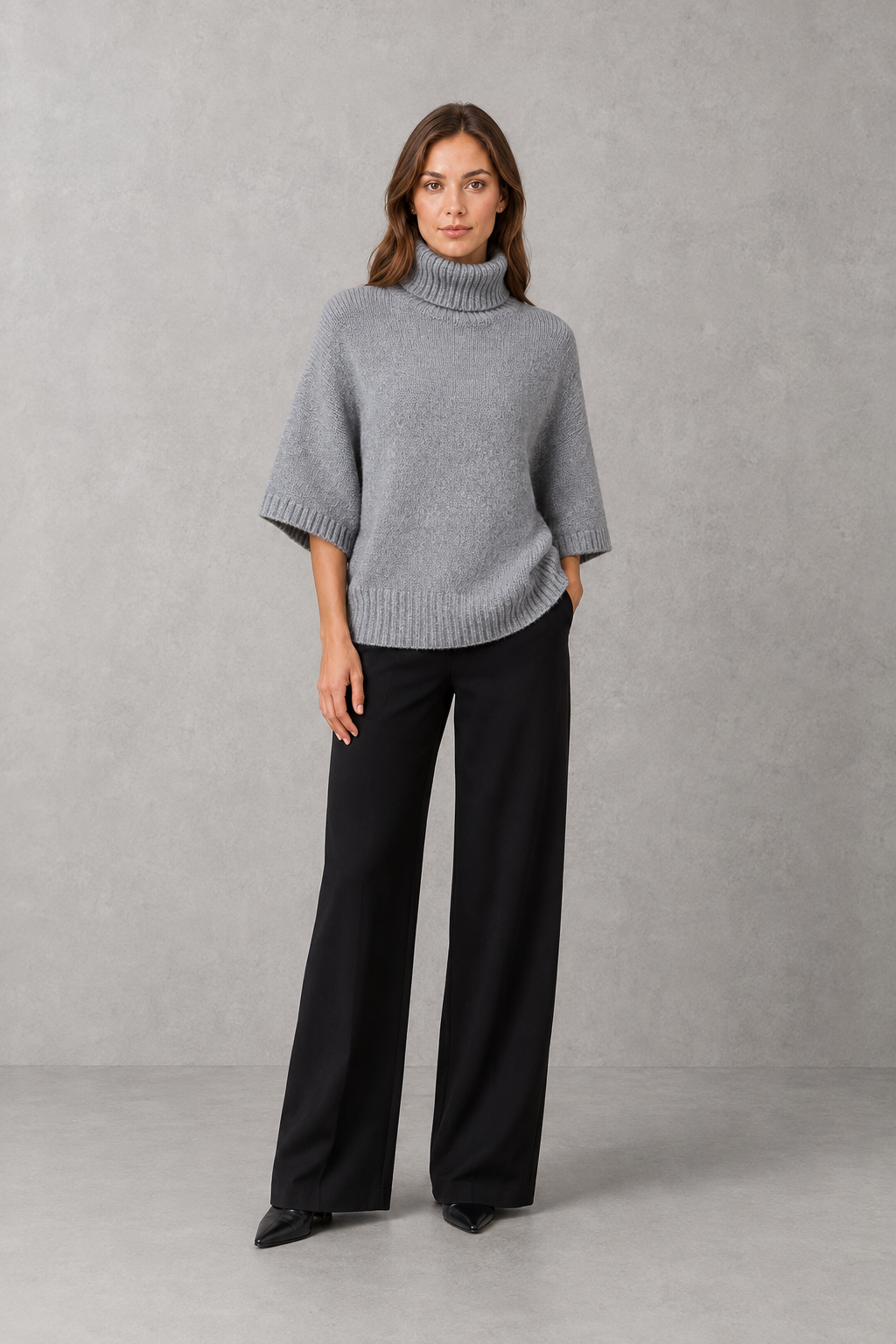 Women’s high neck batwing knit sweater with textured detailing, relaxed poncho-style silhouette, flowing sleeves, and a flattering waist-defining shape.