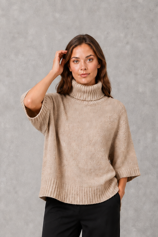 Women’s high neck batwing knit sweater with textured detailing, relaxed poncho-style silhouette, flowing sleeves, and a flattering waist-defining shape.