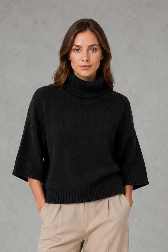Women’s high neck batwing knit sweater with textured detailing, relaxed poncho-style silhouette, flowing sleeves, and a flattering waist-defining shape.