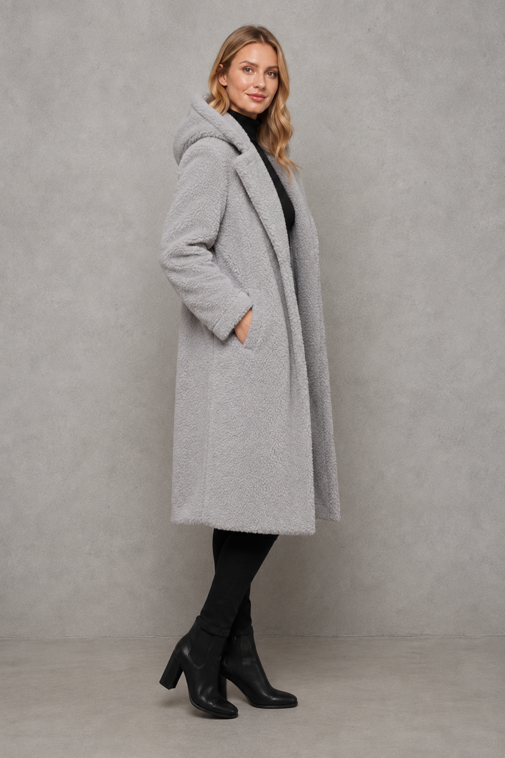 Women’s hooded quilted longline coat with soft insulated padding, a relaxed silhouette, protective hood and deep side pockets.