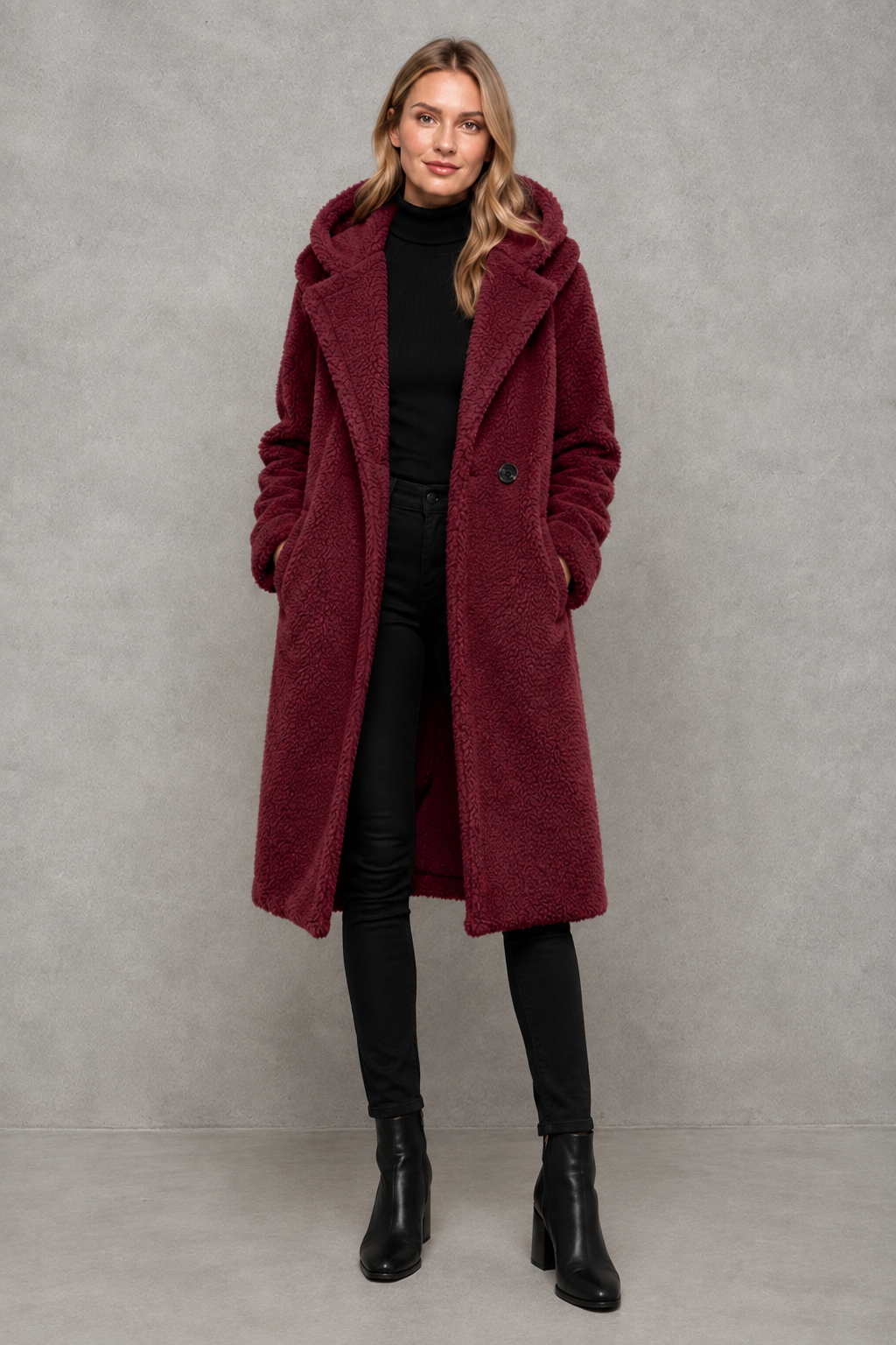 Women’s hooded quilted longline coat with soft insulated padding, a relaxed silhouette, protective hood and deep side pockets.