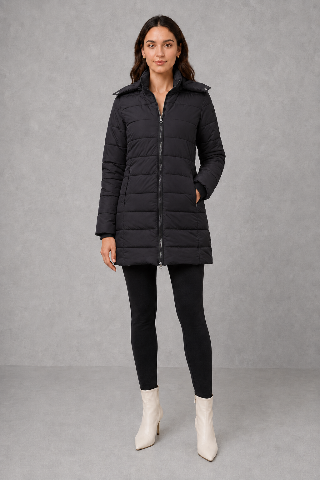 Women’s insulated hooded puffer coat with lightweight padding, protective hood, full-length front zipper, and a streamlined silhouette for cold-weather wear.