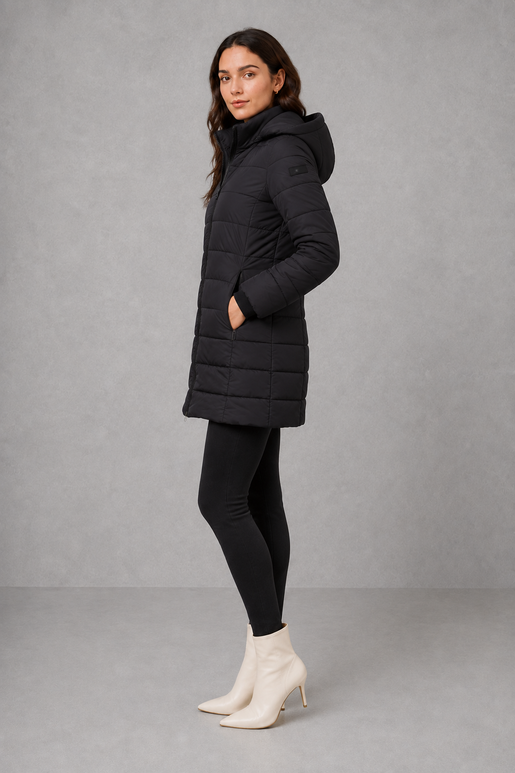 Women’s insulated hooded puffer coat with lightweight padding, protective hood, full-length front zipper, and a streamlined silhouette for cold-weather wear.