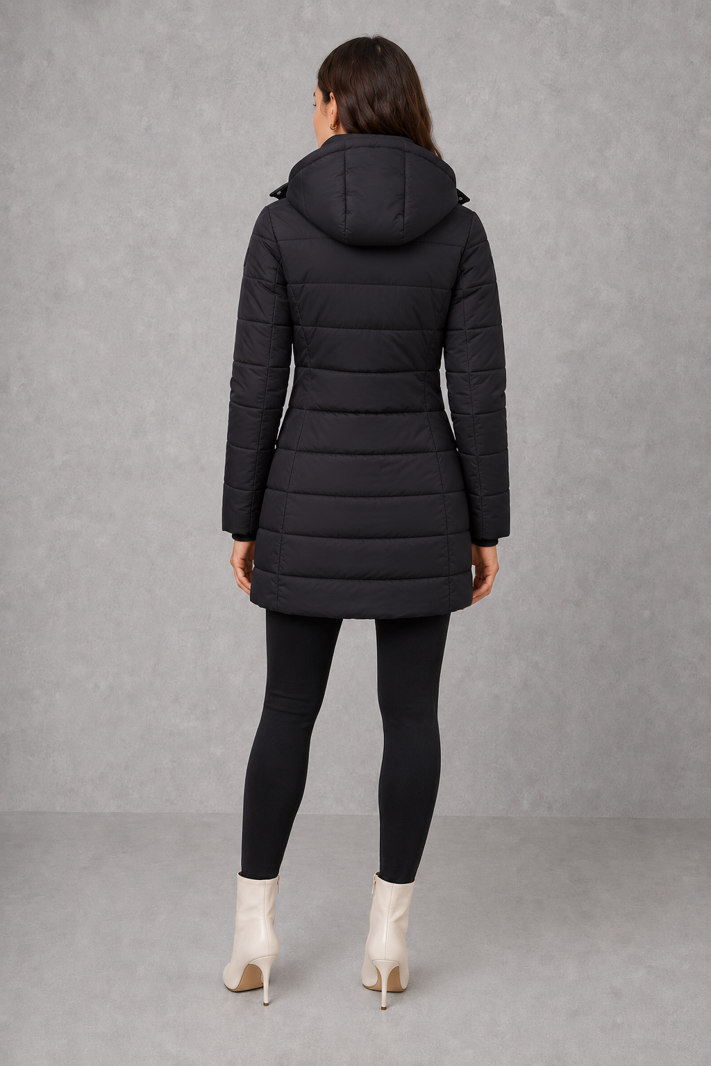 Women’s insulated hooded puffer coat with lightweight padding, protective hood, full-length front zipper, and a streamlined silhouette for cold-weather wear.