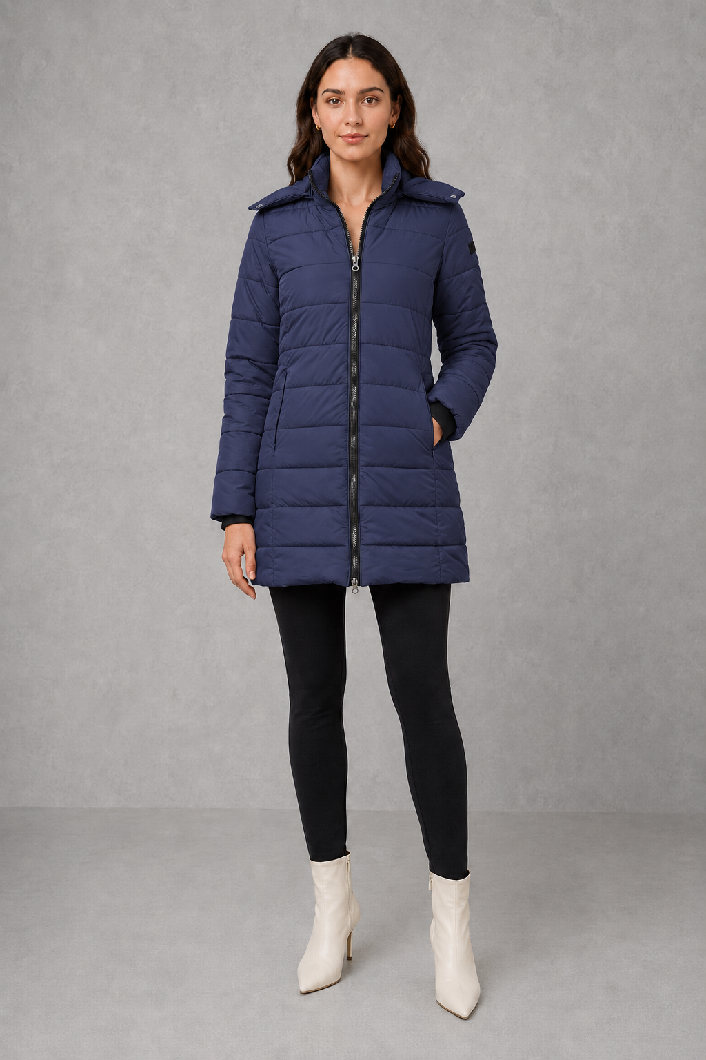 Women’s insulated hooded puffer coat with lightweight padding, protective hood, full-length front zipper, and a streamlined silhouette for cold-weather wear.