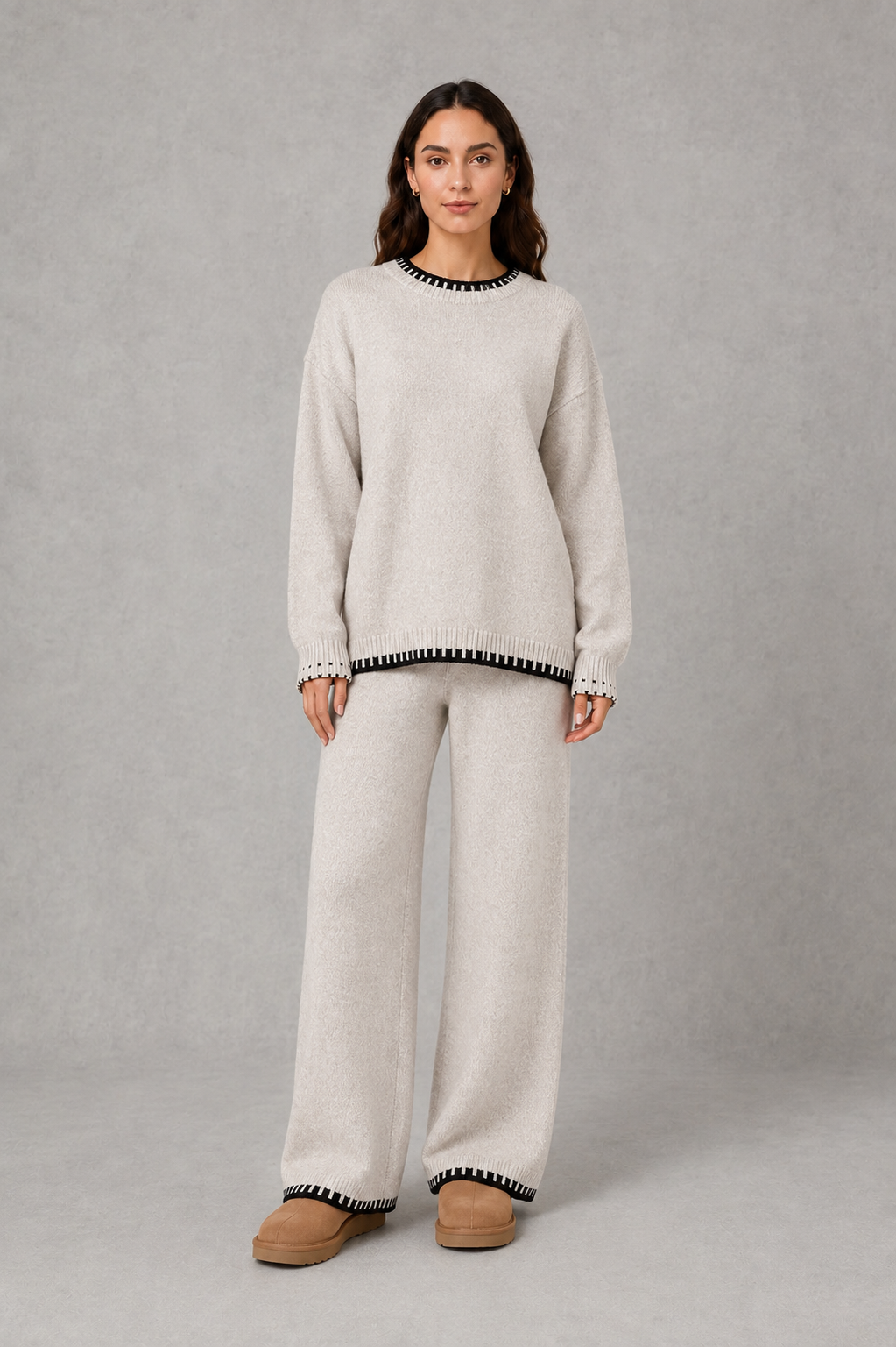 Women’s two-piece knit set featuring a relaxed crew-neck sweater with contrast trim and matching wide-leg knit pants.