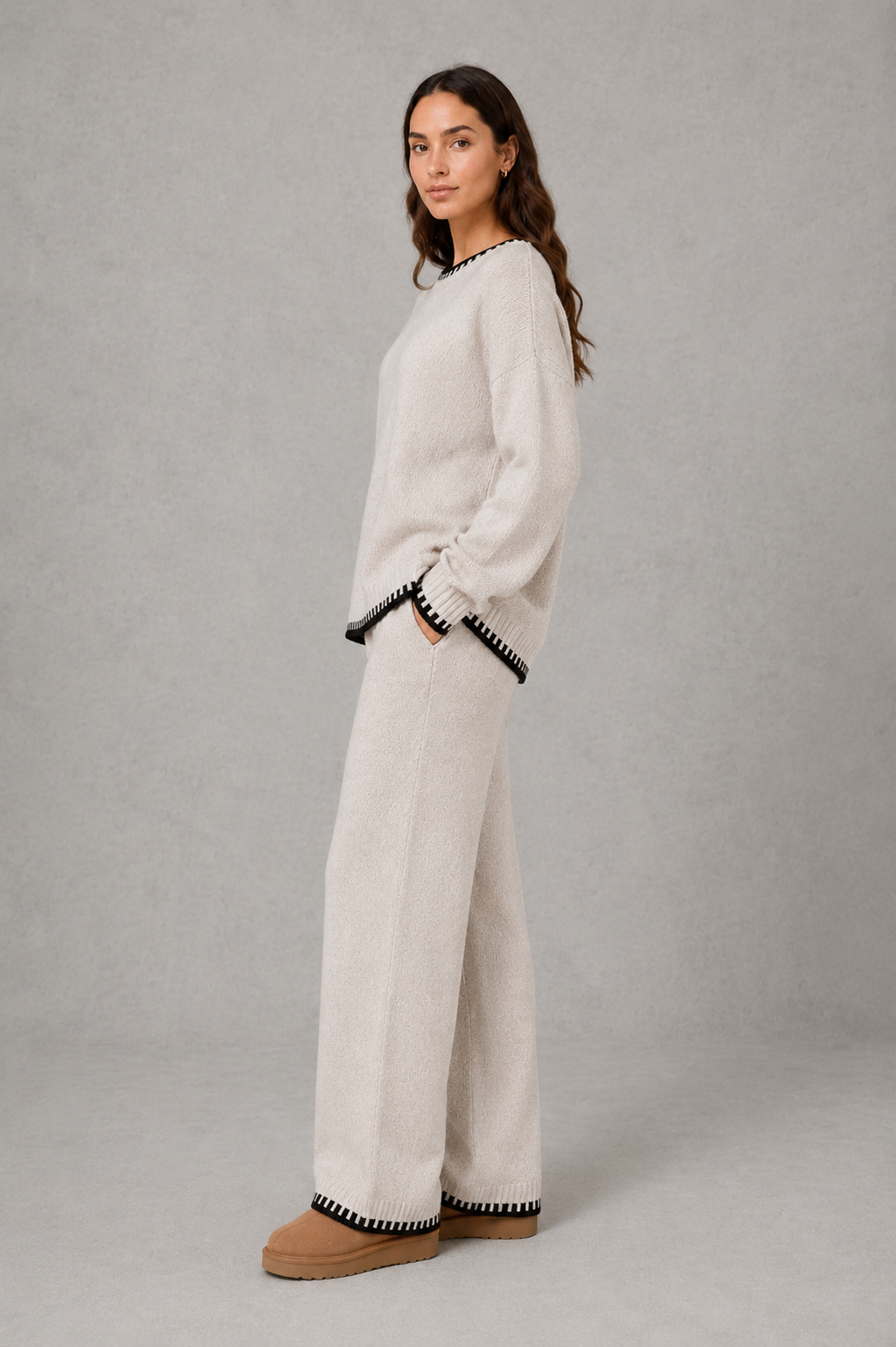 Women’s two-piece knit set featuring a relaxed crew-neck sweater with contrast trim and matching wide-leg knit pants.