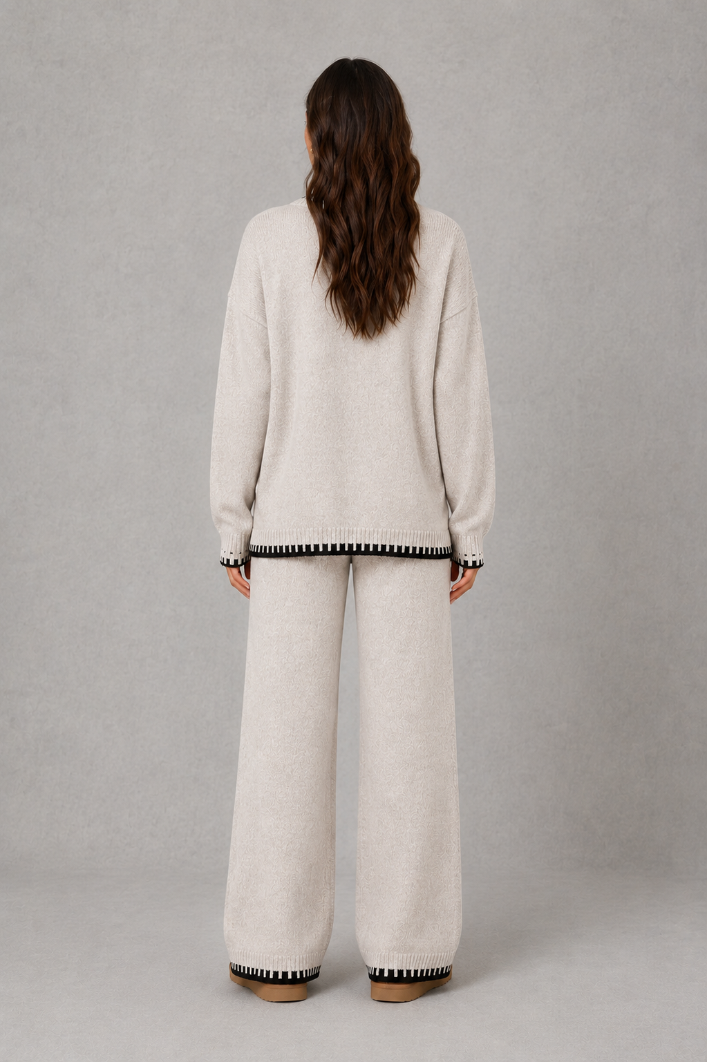 Women’s two-piece knit set featuring a relaxed crew-neck sweater with contrast trim and matching wide-leg knit pants.
