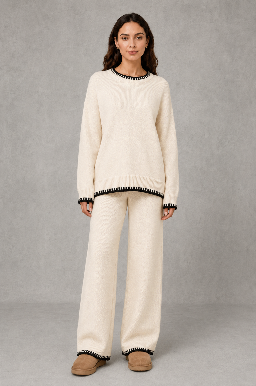 Women’s two-piece knit set featuring a relaxed crew-neck sweater with contrast trim and matching wide-leg knit pants.