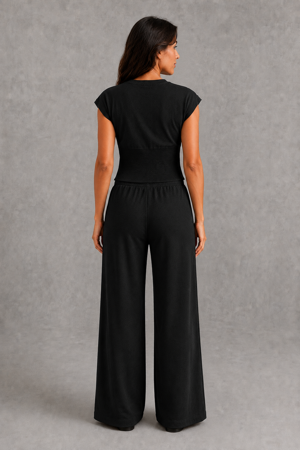 Women’s knit two-piece set featuring a sleeveless button-front top with ribbed waist detailing and matching drawstring wide-leg pants.