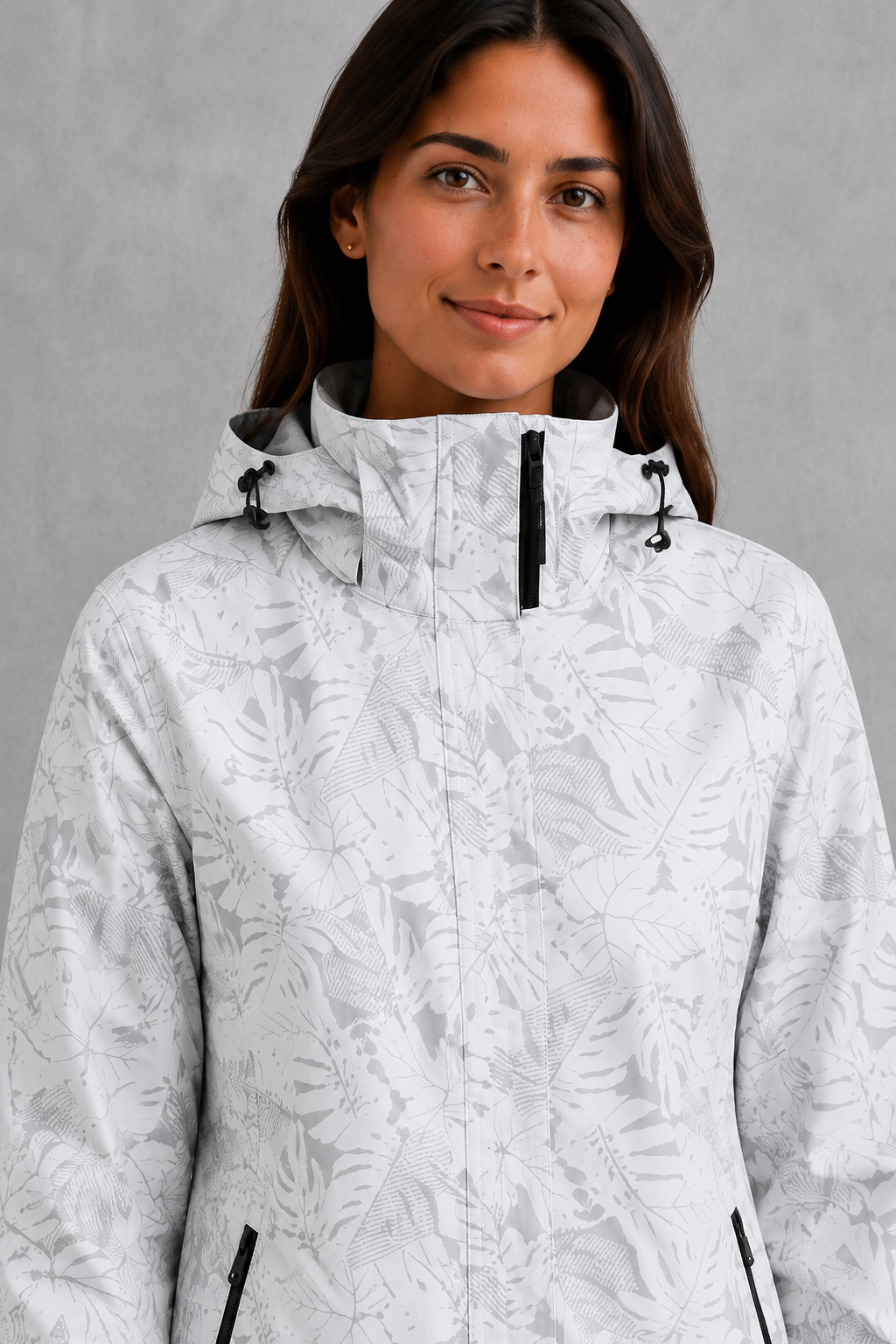 Women’s leaf print hooded rain jacket with a botanical pattern, adjustable drawstring waist and lightweight waterproof, windproof construction.